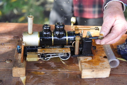 This model steam engine, is a real fuel burning, steam boiler, locomotive.
It is running on steam, with a little oil, and condensate spewing from the stack.