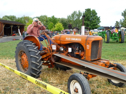 Vern, running the tractor for the threshing machine. Please see the movies of the threshing.